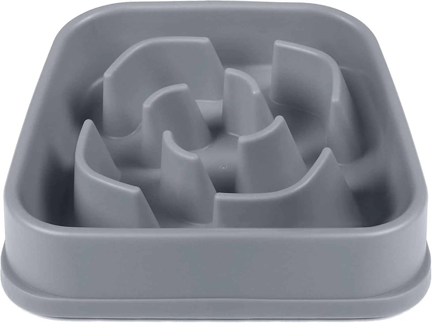 A maze-style slow feeder dog bowl filled with dry kibble on a countertop